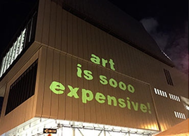 Guerrilla Girls projection on the Whitney Museum with The Illuminator